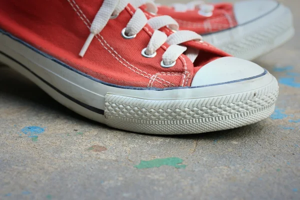 Red sneakers on lawn — Stock Photo, Image