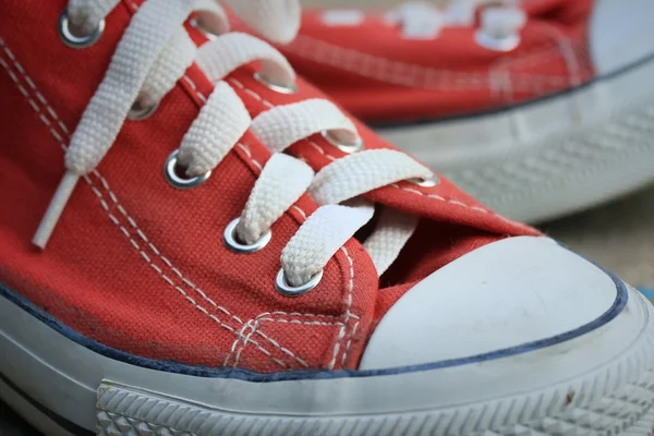 Red sneakers on lawn — Stock Photo, Image