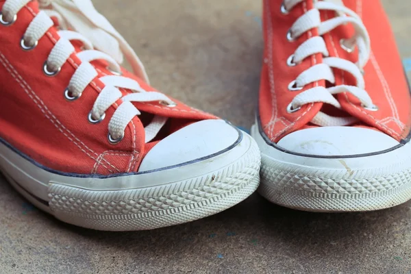 Red sneakers on lawn — Stock Photo, Image