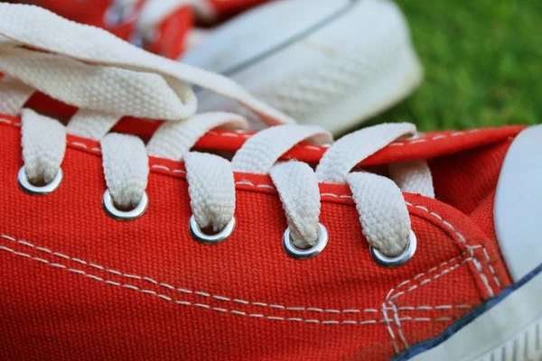 Red sneakers on lawn — Stock Photo, Image