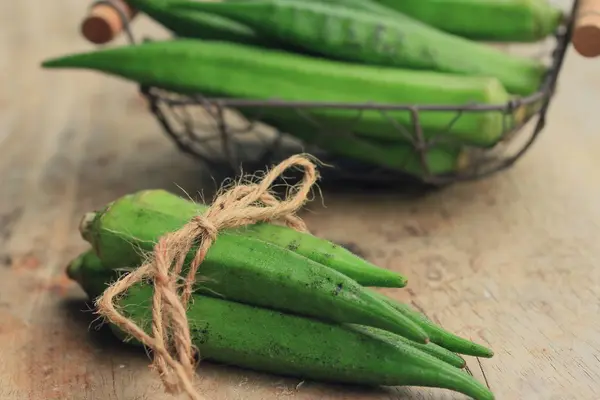 Okra on wood background — Stock Photo, Image