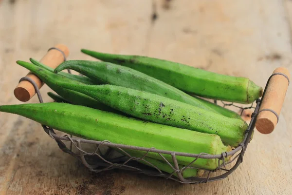 Okra on wood background — Stock Photo, Image