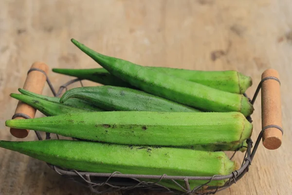 Okra on wood background — Stock Photo, Image