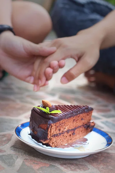 Chocolate cake and handshake symbol of love.