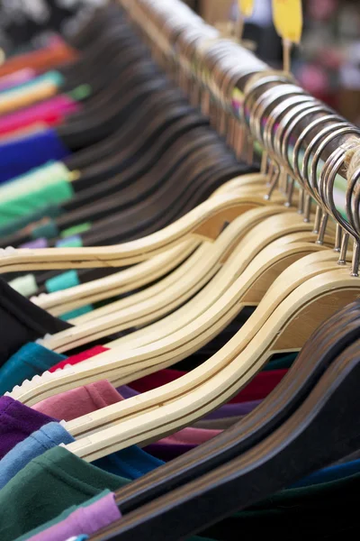 Shop shirts colorful fabric hanging on a rack. — Stock Photo, Image