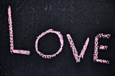 Aşk kelimesi tahtada yazılı.