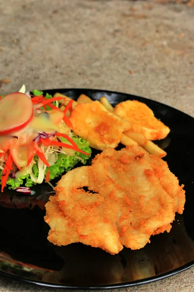 Steaks, french fries with vegetables salad on a plate — Stock Photo, Image