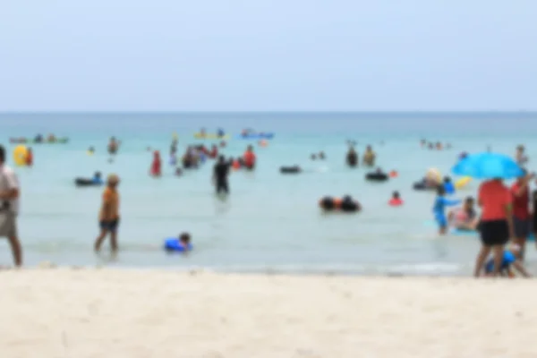 Verschwommene Menschen am Strand — Stockfoto