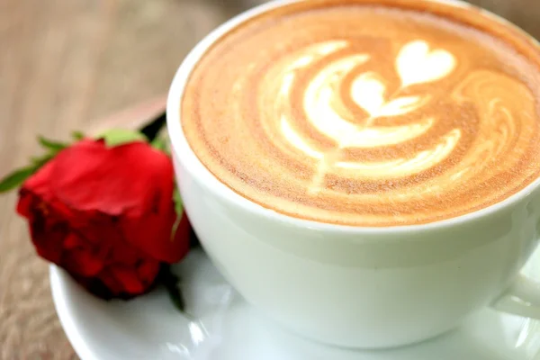 Vintage latte art coffee and red rose — Stock Photo, Image
