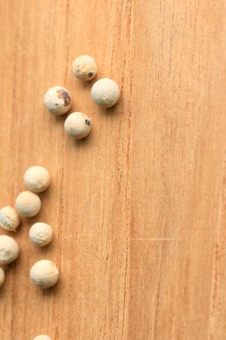 ahşap arka plan üzerinde beyaz biber tohumları.