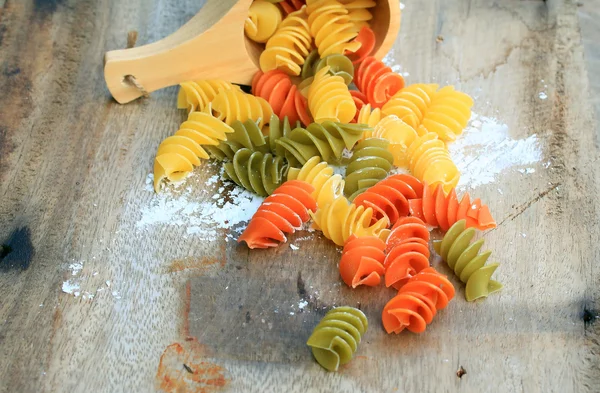Raw pasta on old wooden — Stock Photo, Image
