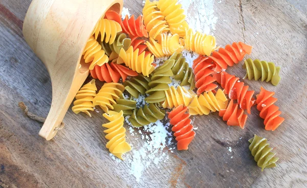 Raw pasta on old wooden