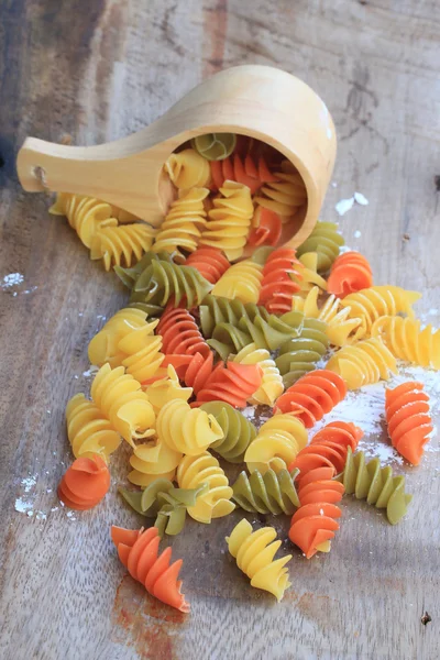 Raw pasta on old wooden — Stock Photo, Image