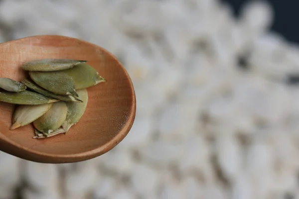 Pumpkin seeds on a black background — Stock Photo, Image