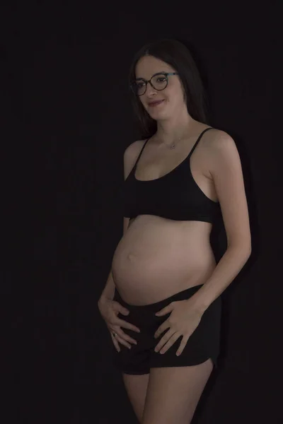 Pregnant Woman Wearing Underclothes Holding Her Belly Standing Black Background — Stock Photo, Image