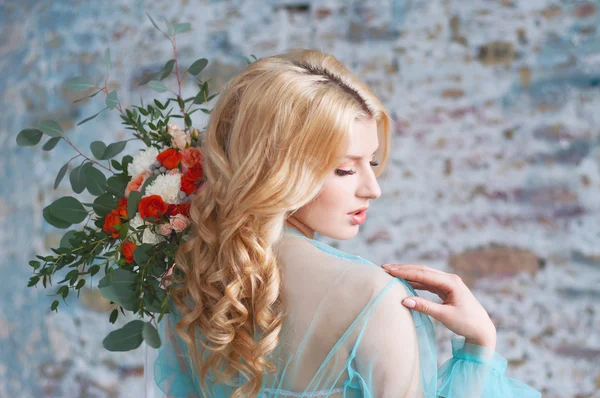 Charming young blond woman holding fresh flowers — Stok fotoğraf