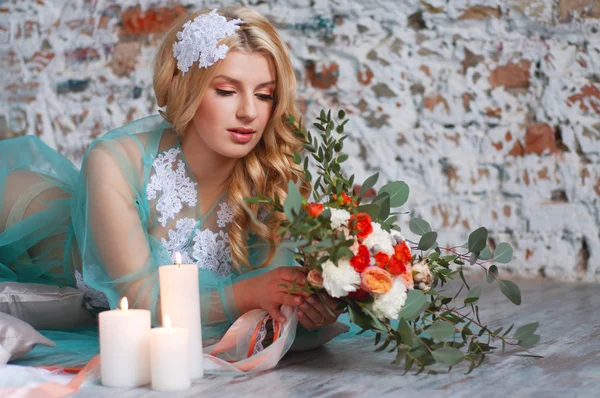 Charming young blond woman holding fresh flowers — Stockfoto