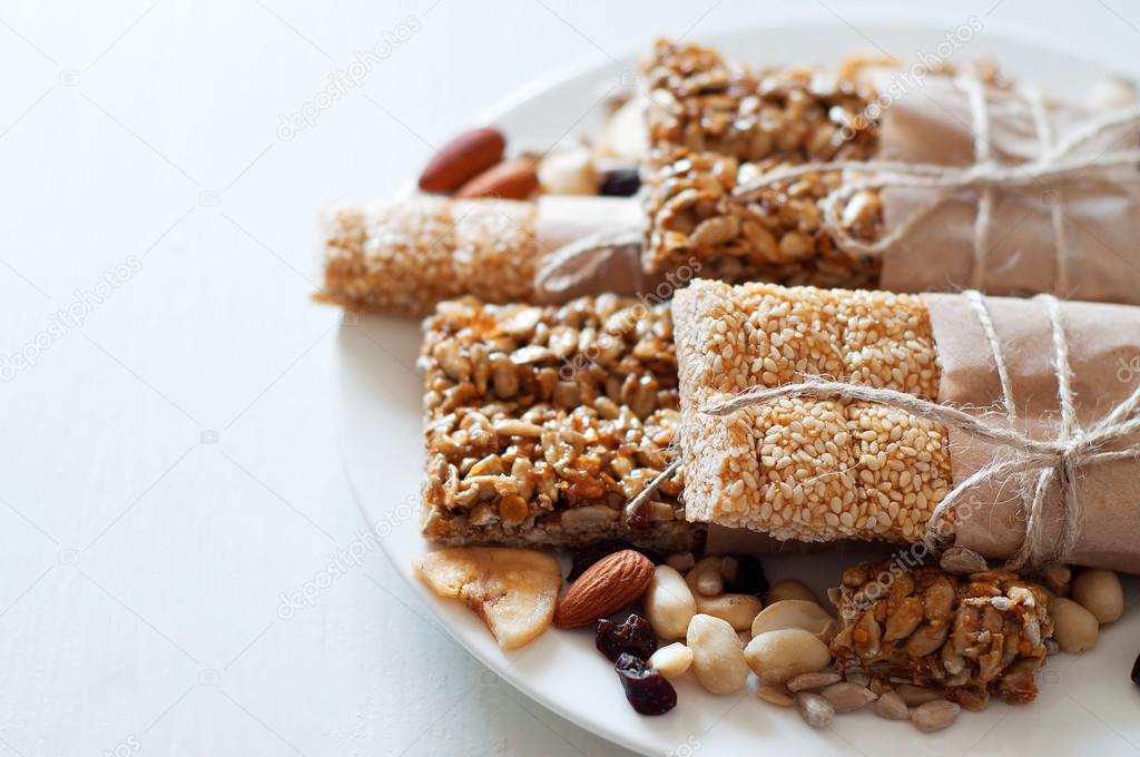 Granola bars made of sesame seeds, peanuts, cashew nuts. Stock Photo by