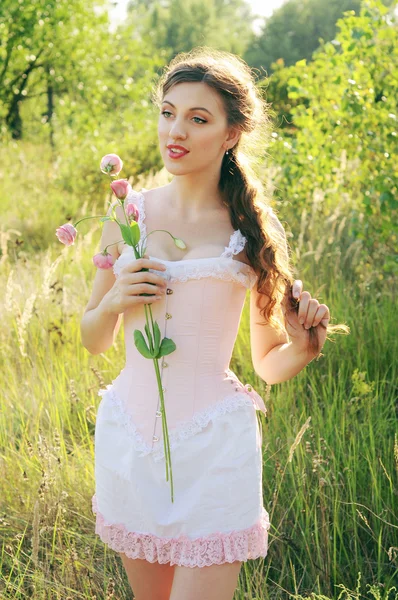 Young bride in a pink corset outdoors — Stock Photo, Image