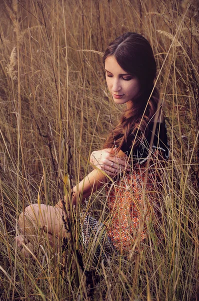 Cute young woman in the autumn field — Stock Photo, Image