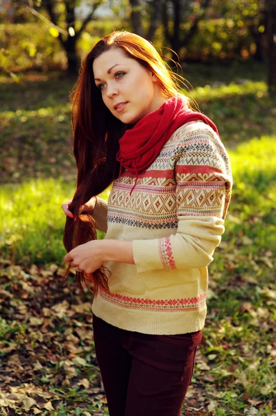 Young redheaded woman with long straight hair in the apple garde — Stock Photo, Image