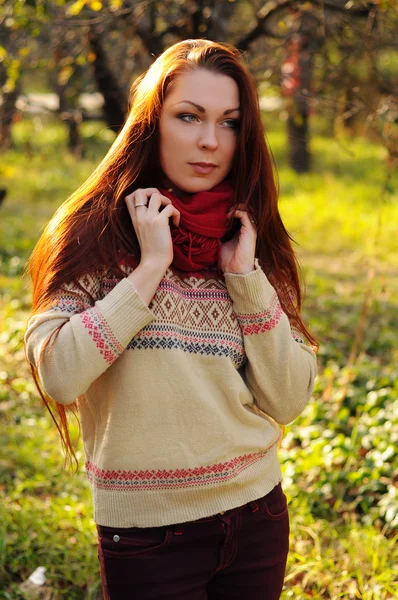 Young redheaded woman with long straight hair in the apple garde — Stock Photo, Image