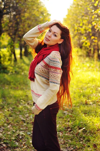 Young redheaded woman with long straight hair in the apple garde — Stock Photo, Image