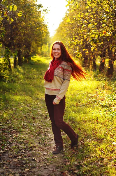 Young redheaded woman with long straight hair in the apple garde — Stock Photo, Image