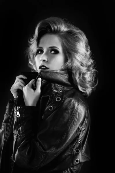Studio portrait of blonde woman in leather biker jacket. — Stock Photo, Image