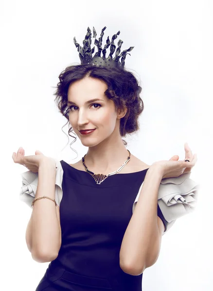 Studio portrait of a beautiful brunette with a crown — Stock Photo, Image