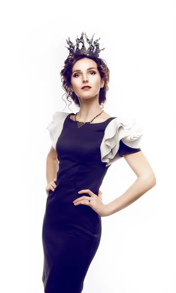 Studio portrait of a beautiful brunette with a crown — Stock Photo, Image