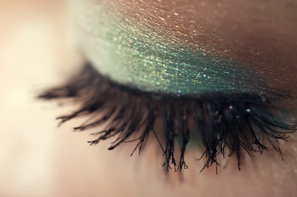 Eye closeup with shiny makeup in teal and beige — Stock Photo, Image