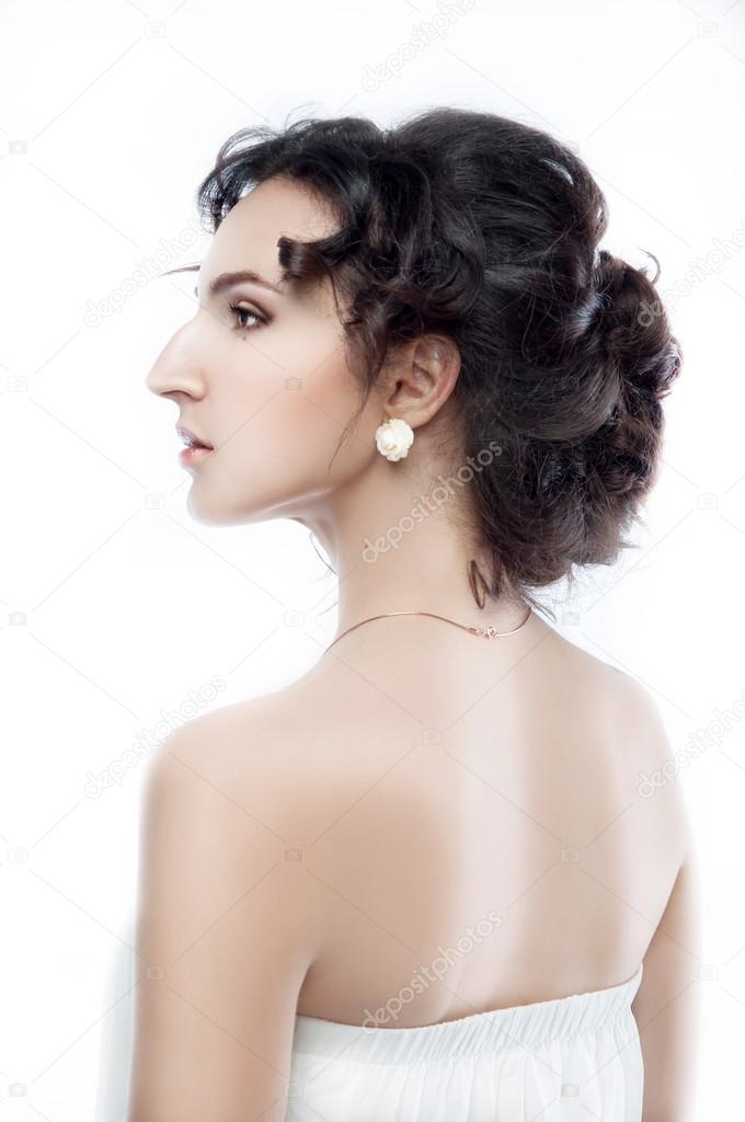 Studio portrait of a beautiful brunette with evening hairdo and 