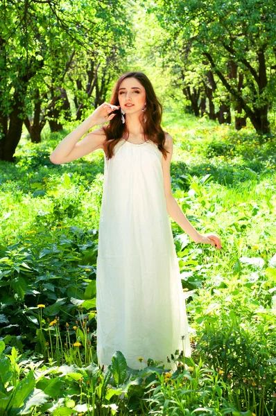 Woman in a long white dress — Stock Photo, Image