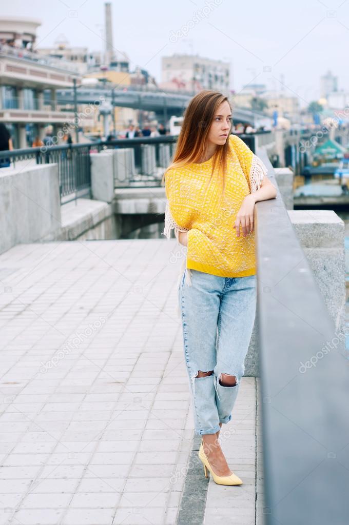 Street city fashion redheaded girl with long hair