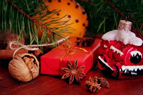Winter present under christmas tree with nuts and spices — Stock Photo, Image