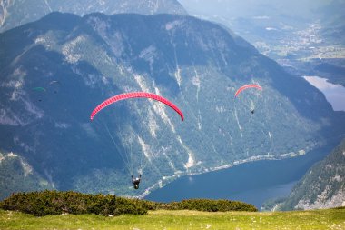 Paragliding at the Dachstein Mountains clipart