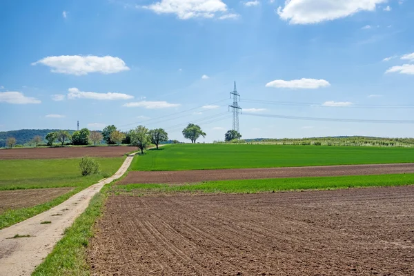 Landweg via landbouwgrond — Stockfoto