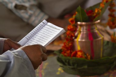 Brahman reading hindu mantra in Nepal clipart