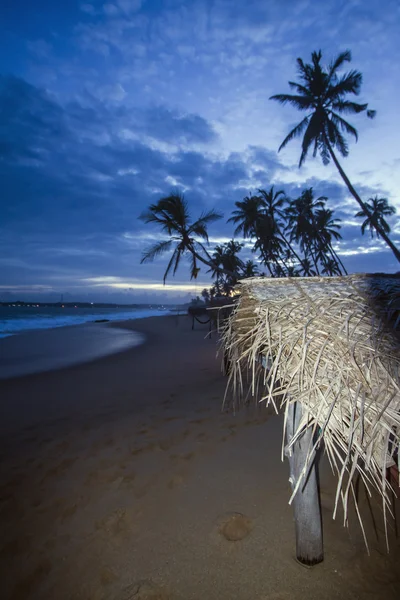 Grass hut in paradise wild beach by night — Stock Photo, Image