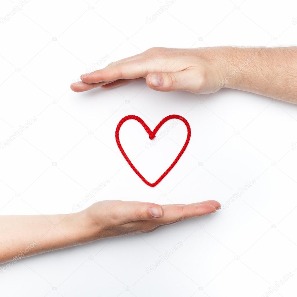 Two hands with red heart