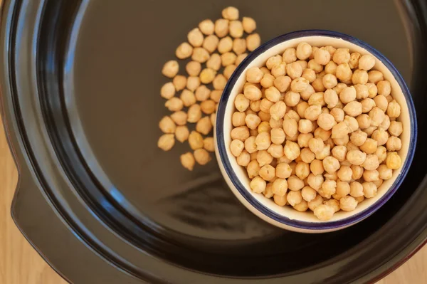 Overhead view of bowl filled with chick peas inside a tagine — Stock Photo, Image