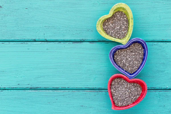 Heart shape ceramic bowls with Chia seeds — Stock Photo, Image