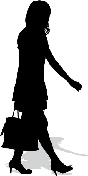 Silhouette vettoriale della donna che cammina con una borsa — Vettoriale Stock