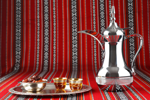 Iconic Abrian fabric with Arabic tea and dates symbolise Arabian hospitality