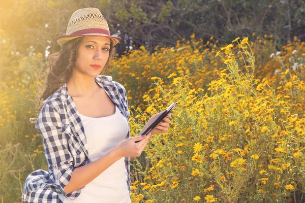 Portrait of young beautiful smiling woman with tablet outdoors — Stock Photo, Image