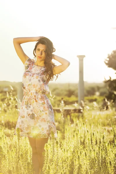 Very attractive girl in a field of flowers — Stock Photo, Image