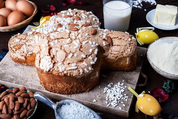 dove easter cake (Colomaba Pasquale) Italian traditional Easter cake on a plank board with ingredients