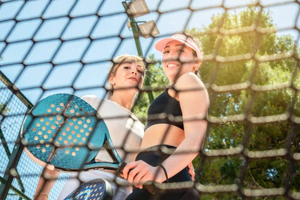 Zwei Lächelnde Mädchen Hinter Einem Tennisnetz Posieren Nach Einem Spiel — Stockfoto