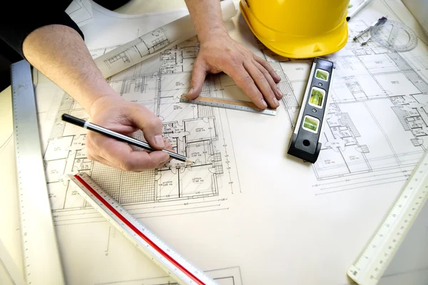 A young architect and the plans for a house — Stock Photo, Image